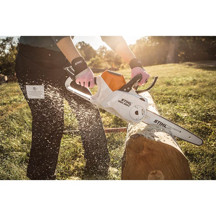 Man outside cutting log with Stihl MSA 200C