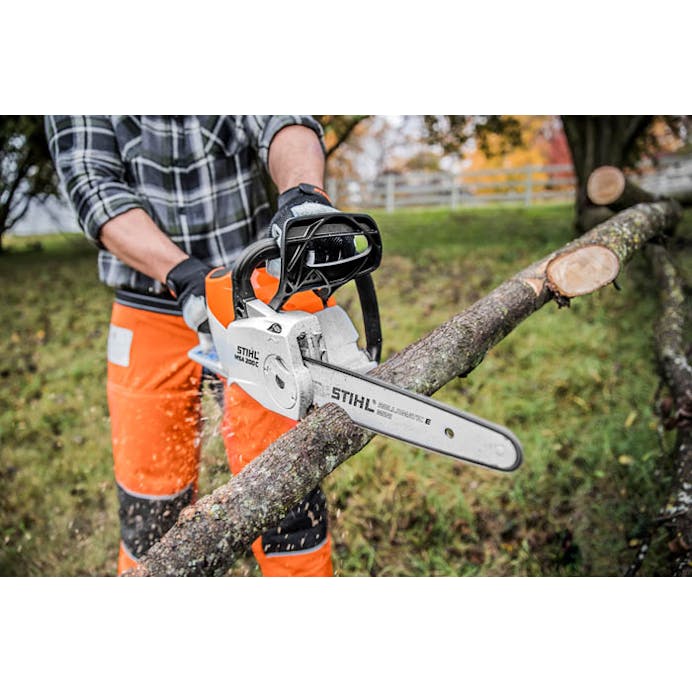 Man cutting branch with the STIHL MS 201 T C-M Chainsaw