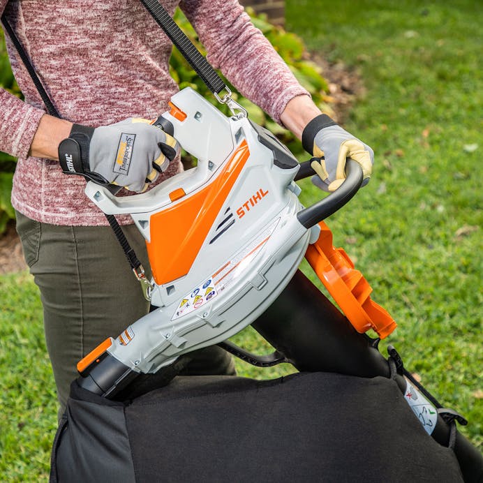 Man holding STIHL® SH 86 C-E in the yard