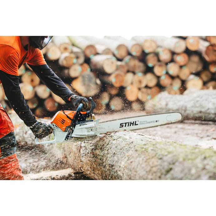 Man cutting log with Stihl chainsaw